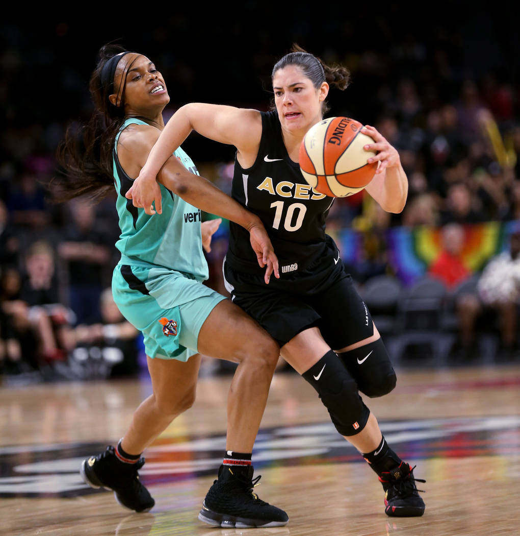 Las Vegas Aces guard Kelsey Plum (10) drives past New York Liberty guard Brittany Boyd (15) in the second half of a WNBA basketball game at the Mandalay Bay Events Center in Las Vegas on Friday, J ...