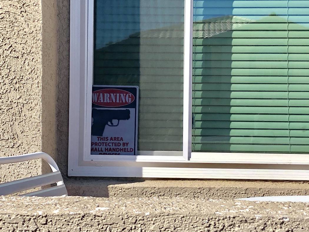 A sign in the window of 2804 Via Bel Mondo Street warning others that the home is "protected" by a "small handheld device." Neighbors said the home was the scene of a murder-suicide on the 2800 bl ...