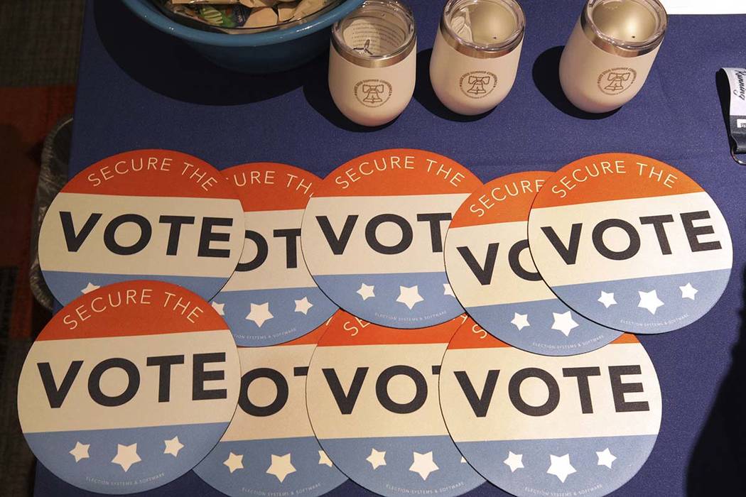 Computer mouse pads with Secure the Vote logo on them are seen on a vendor's table at a convention of state secretaries of state Saturday, July 14, 2018, in Philadelphia. Department of Homeland Se ...