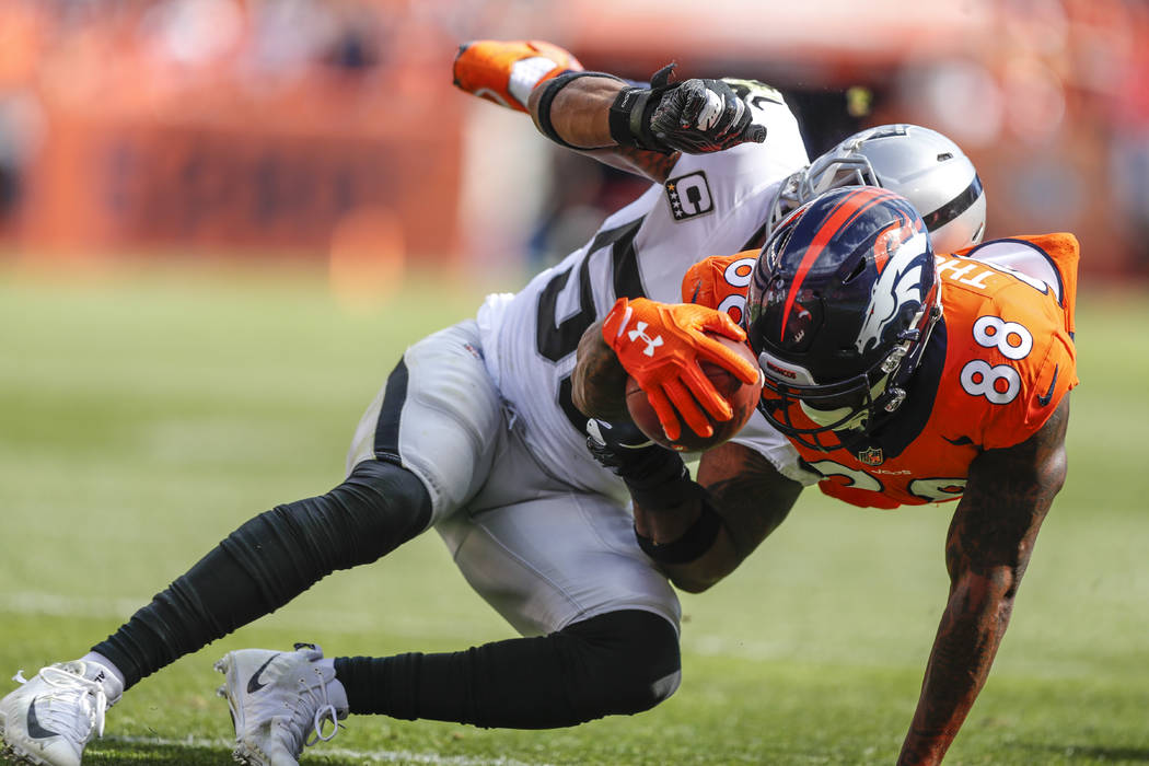 Denver Broncos wide receiver Demaryius Thomas (88) is hit by Oakland Raiders linebacker Derrick Johnson (56) during the second half of an NFL football game, Sunday, Sept. 16, 2018, in Denver. (AP ...