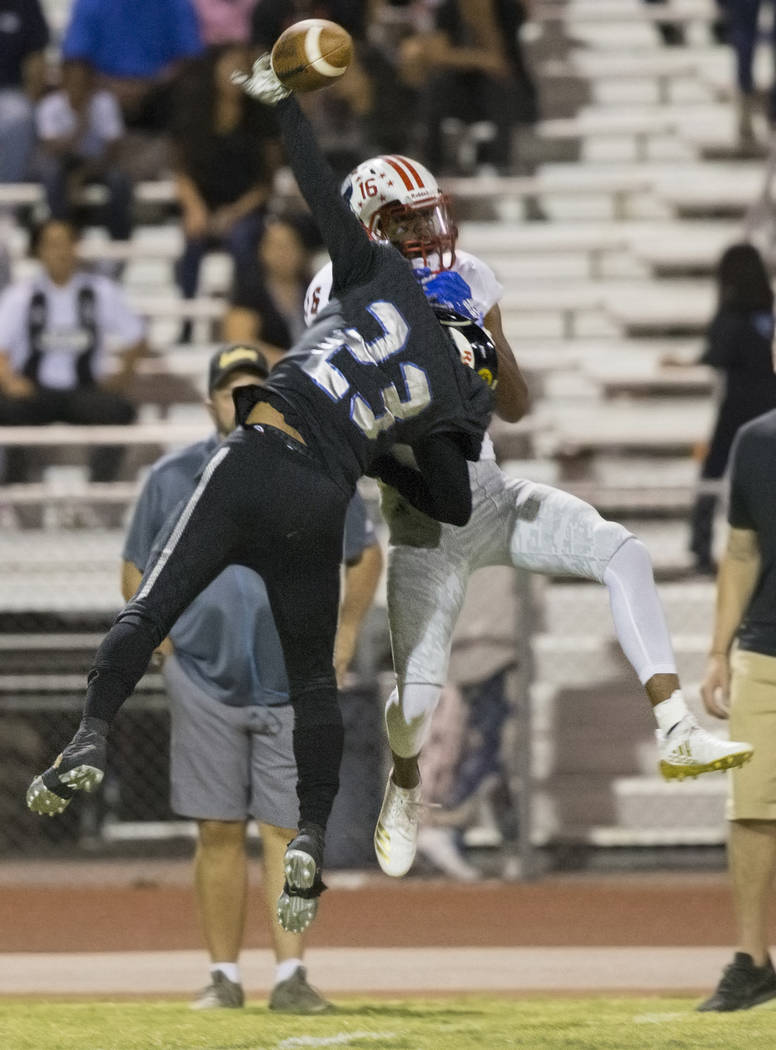 Desert Pines junior cornerback Andrew Williams (23) knocks the ball away from Liberty junior wide receiver Maurice Hampton (16) in the first quarter during the Jaguars home game with the Patriots ...