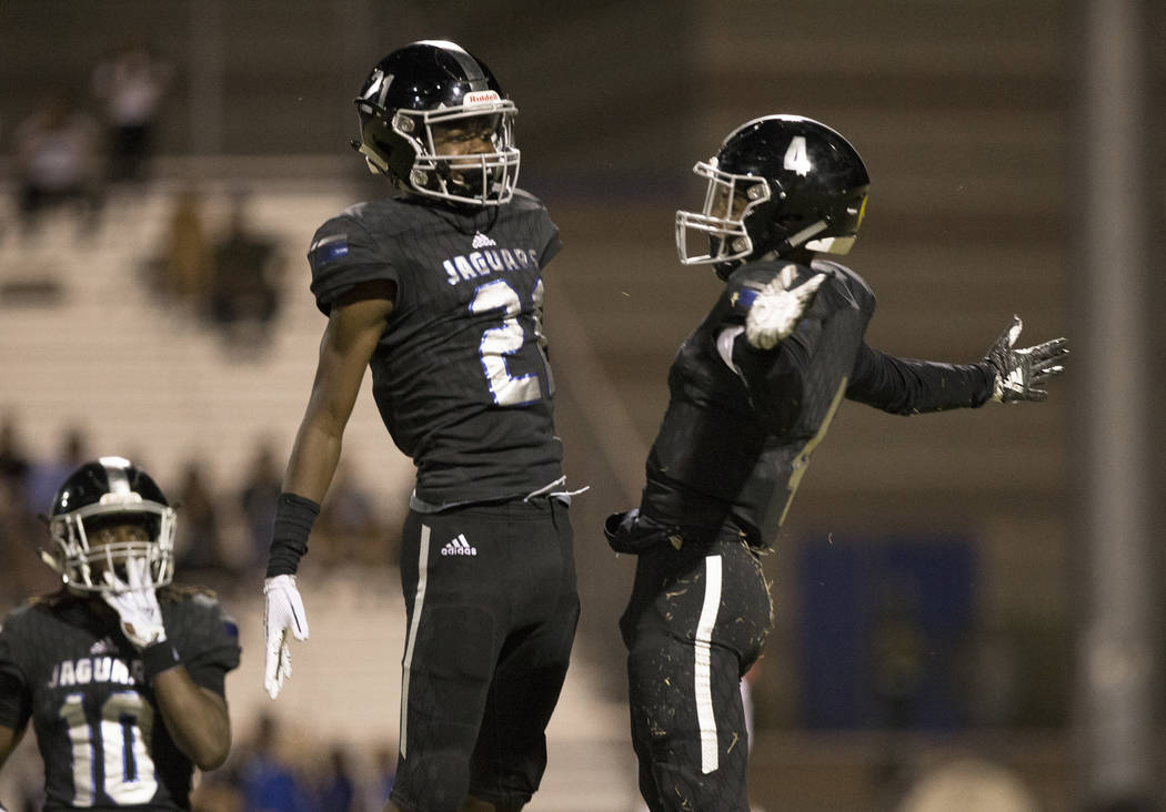 Desert Pines junior wide receiver Branden Thomas (4) celebrates after making a big catch with teammate Ezekiel Washington (21) in the second quarter during the Jaguars home game with the Patriots ...