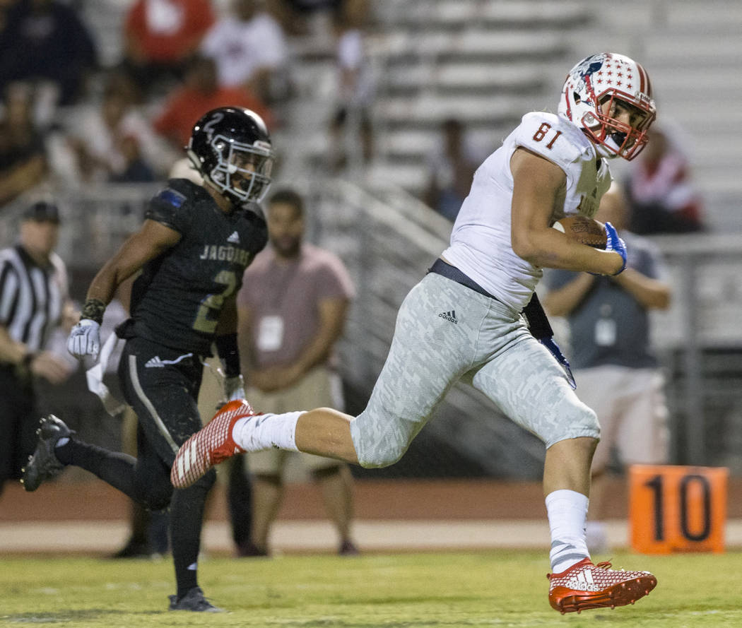 Liberty sophomore tight end Moliki Matavao (81) sprints up field for a fourth quarter touchdown catch past Desert Pines cornerback receiver Tye Moore (2) during the Patriots road game with the Jag ...