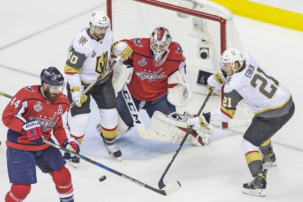 Capitals goaltender Braden Holtby (70) makes a second-period save against Golden Knights center Cody Eakin (21) and center Ryan Carpenter (40) during Game 4 of the NHL Stanley Cup Final on Monday, ...