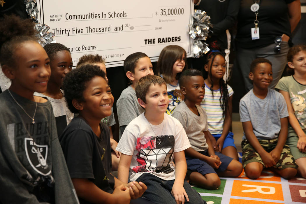 Students smile for a photo after the Raiders presented a $35,000 donation to Communities In Schools of Southern Nevada program which promotes student success for all children, at Robert Taylor Ele ...