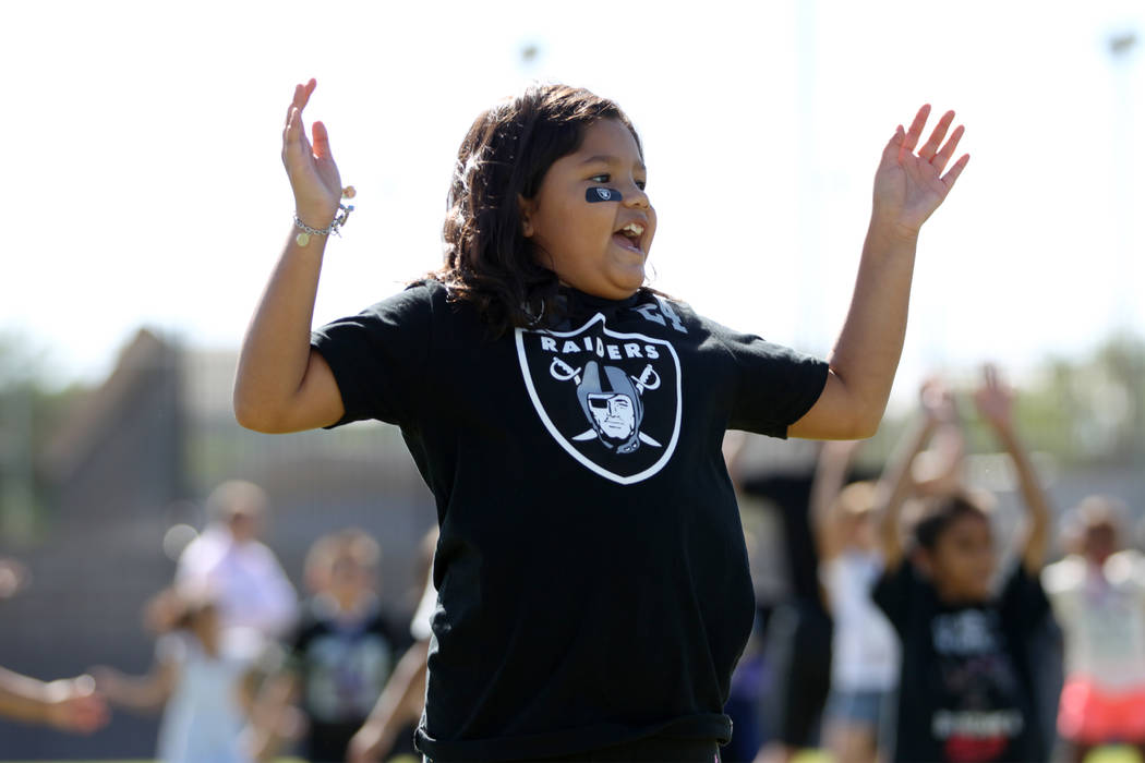 Third grade student Bella Rivera, 8, participates in a Raiders youth football camp at Robert Taylor Elementary School in Henderson, Tuesday, Sept. 25, 2018. The Raiders adopted a Communities In Sc ...