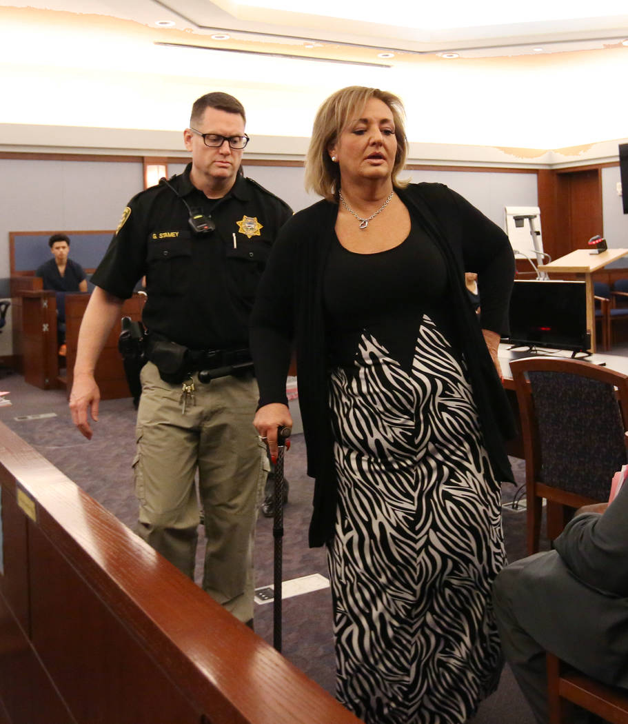 Vicki Greco, right, a suspended Las Vegas attorney who pleaded guilty to three felonies for her role in a scheme to defraud the court system, led out of the courtroom after her sentencing at the R ...