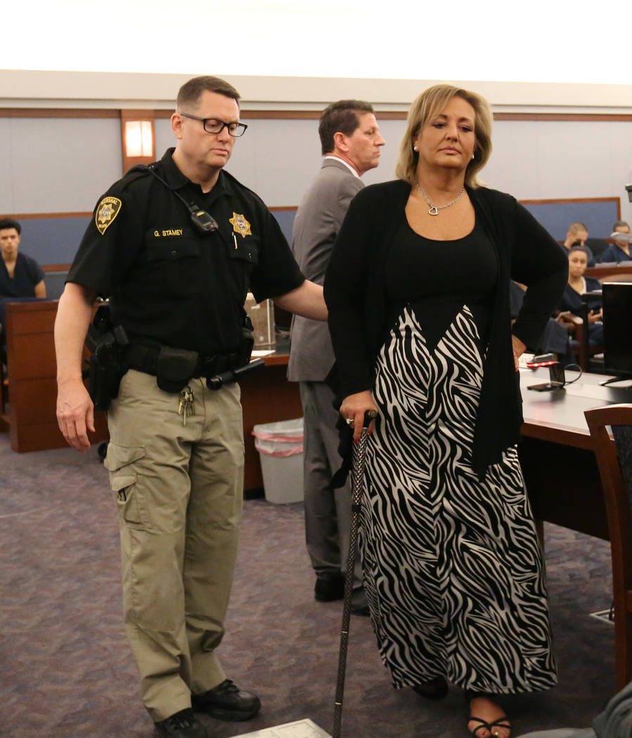 Vicki Greco, right, a suspended Las Vegas attorney who pleaded guilty to three felonies for her role in a scheme to defraud the court system, led out of the courtroom after her sentencing at the R ...