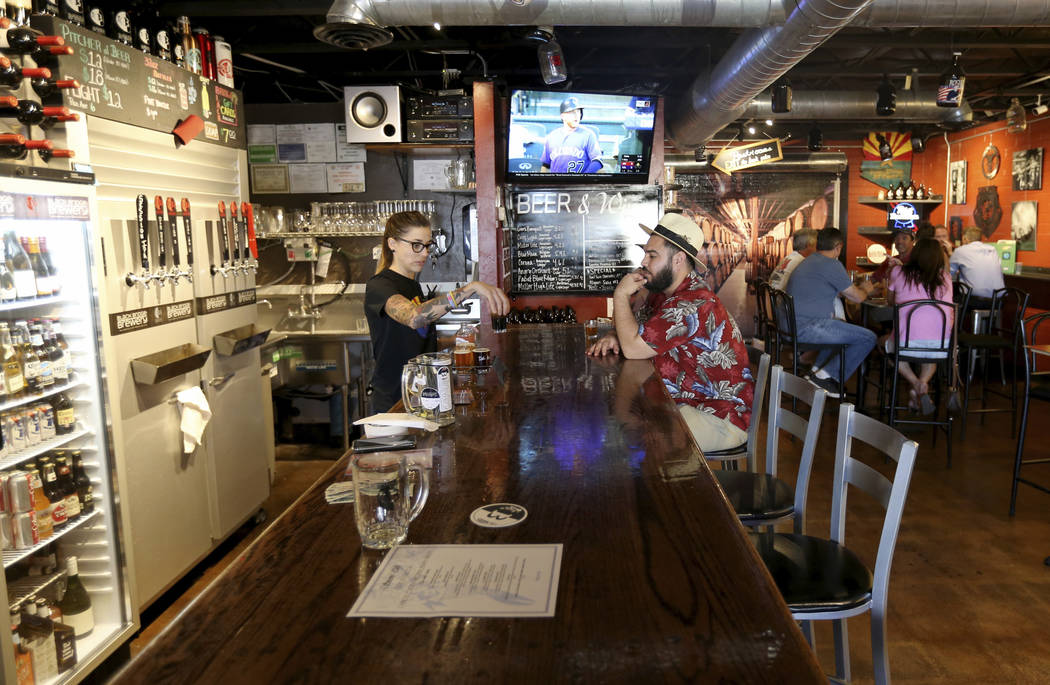 Heather Howell serves beer at Black Bridge Brewery in Kingman, Ariz. Wednesday, Sept. 12, 2018. "I like small towns and nice people, and we've got a lot of both right here." said Howell. ...