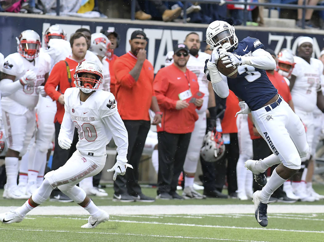 Utah State safety Jontrell Rocquemore (3) intercepts a pass intended for UNLV wide receiver Brandon Presley (80) during an NCAA college football game Saturday, Oct. 13, 2018, in Logan, Utah. (Eli ...