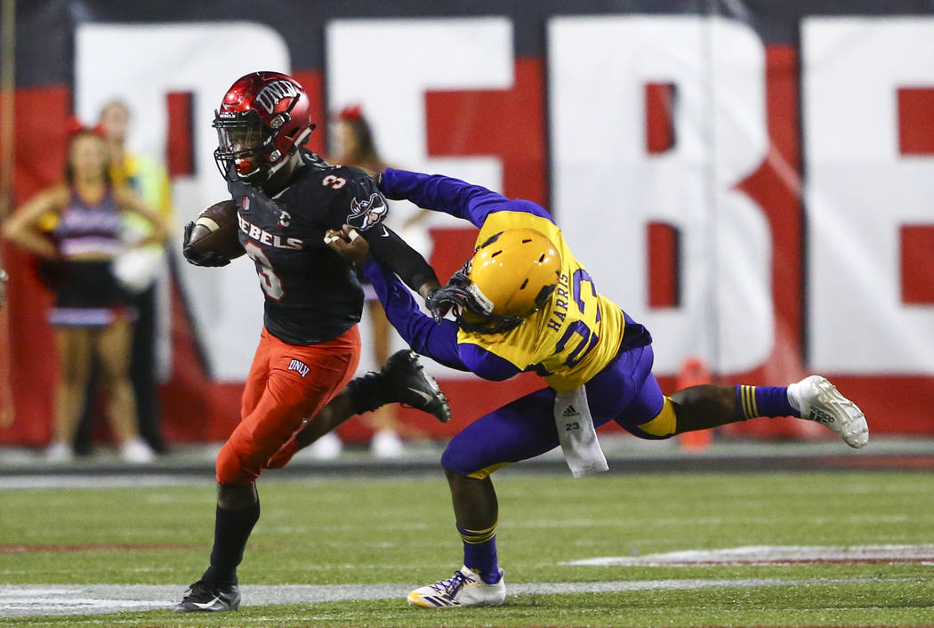 Prairie View A&M Panthers cornerback Jaylen Harris (23) tries to take down UNLV Rebels running back Lexington Thomas (3) during the second half of a football game at Sam Boyd Stadium in Las Ve ...