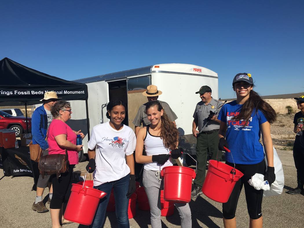 From left, Mirrorajah Metcalfe, 16, Tahoe Mack, 17, and Dani Mason, 17, take part in a cleanup event at Tule Springs Fossil Beds National. (Dawn Mack)