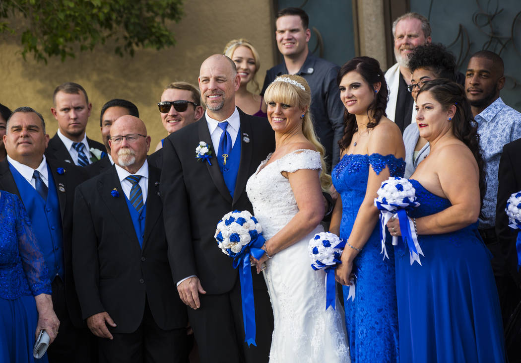 Todd Wienke and Oshia Wienke, center, pose for a group photo after their wedding ceremony at Chapel of the Flowers in Las Vegas on Monday, Oct. 1, 2018. Todd was shot three times as he shielded Os ...