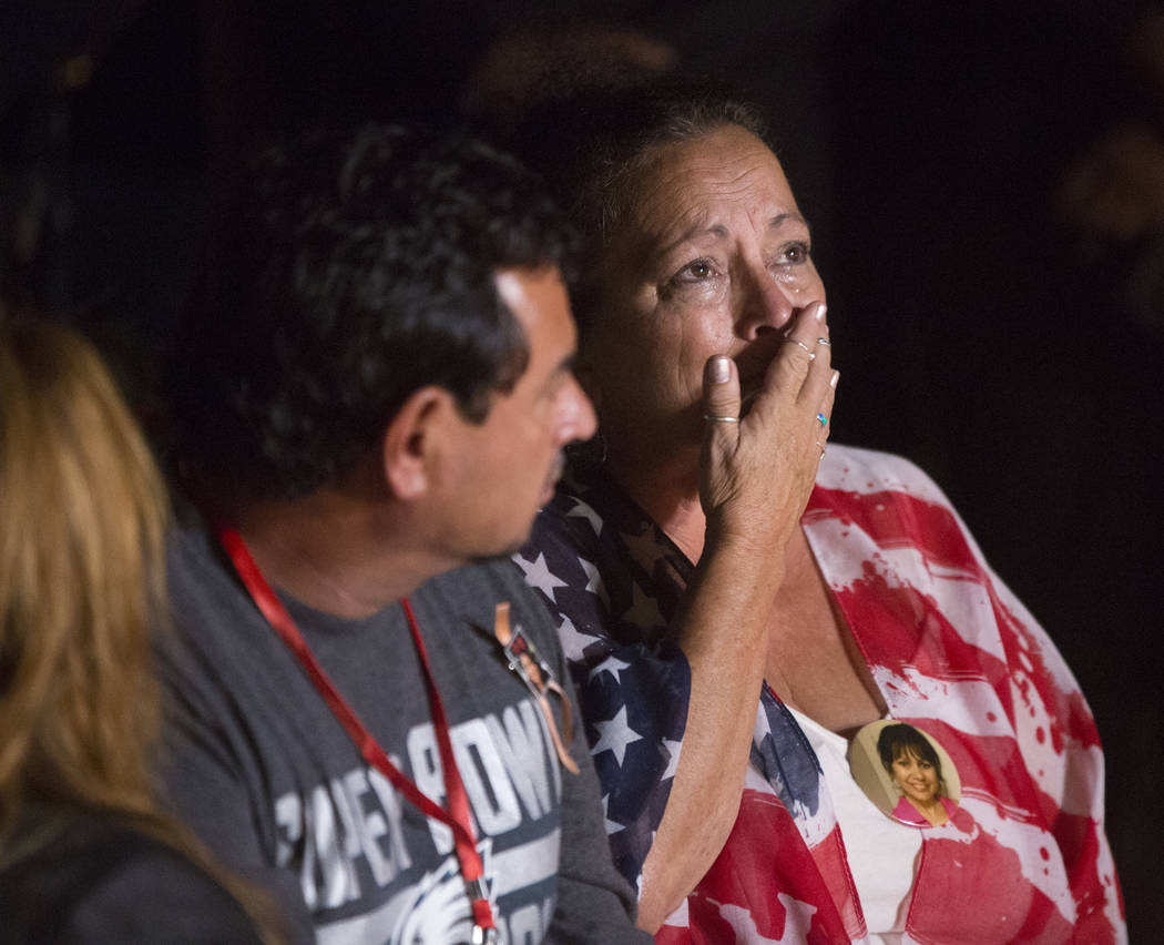 Family members of those killed in the Oct 1 shooting grieve while the names of their loved ones are read during a ceremony organized by the City of Las Vegas in conjunction with Get Outdoors Nevad ...