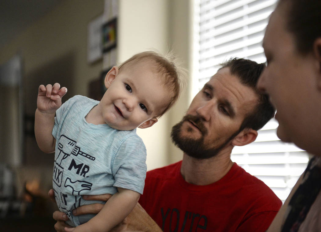 Wyatt Matheson, 1, stands on the lap of his father, Travis Matheson, in their home in Las Vegas, Sunday, Sept. 30, 2018. Caroline Brehman/Las Vegas Review-Journal