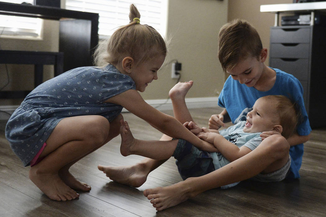 Lylah Matheson, 4, left, and Ryder Matheson, 8, tickle their younger brother, Wyatt Matheson, 1, in their home in Las Vegas, Sunday, Sept. 30, 2018. Caroline Brehman/Las Vegas Review-Journal