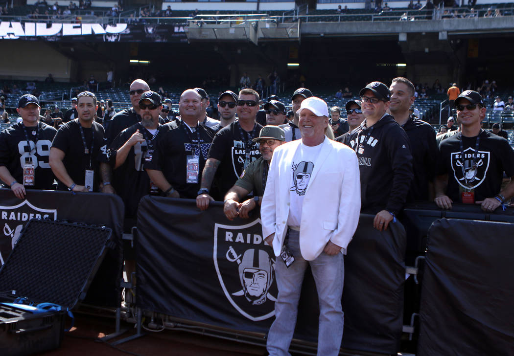 Oakland Raiders owner Mark Davis meets with Las Vegas Metro Police and Las Vegas Fire and Rescue members in Oakland, Calif., Sunday, Sept. 30, 2018. They were invited to the game against the Cleve ...
