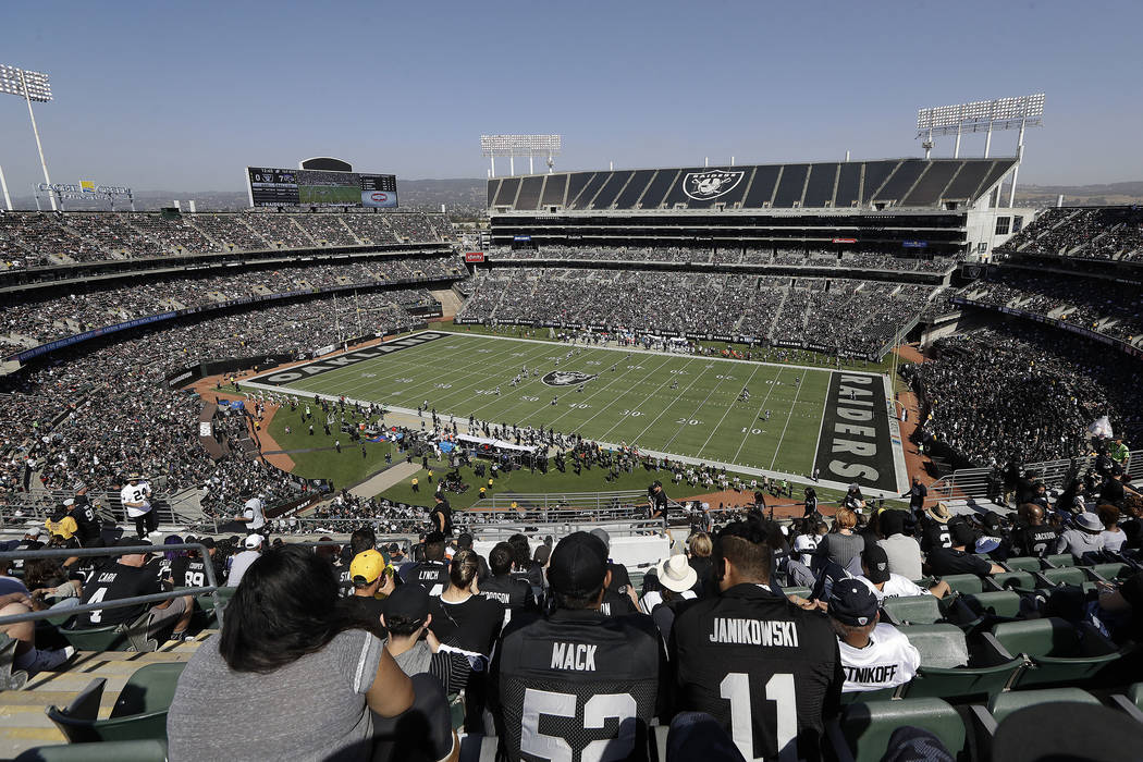 Fans watch from a general view at Oakland Alameda County Coliseum during the first half of an NFL football game between the Oakland Raiders and the Baltimore Ravens in Oakland, Calif., Sunday, Oct ...