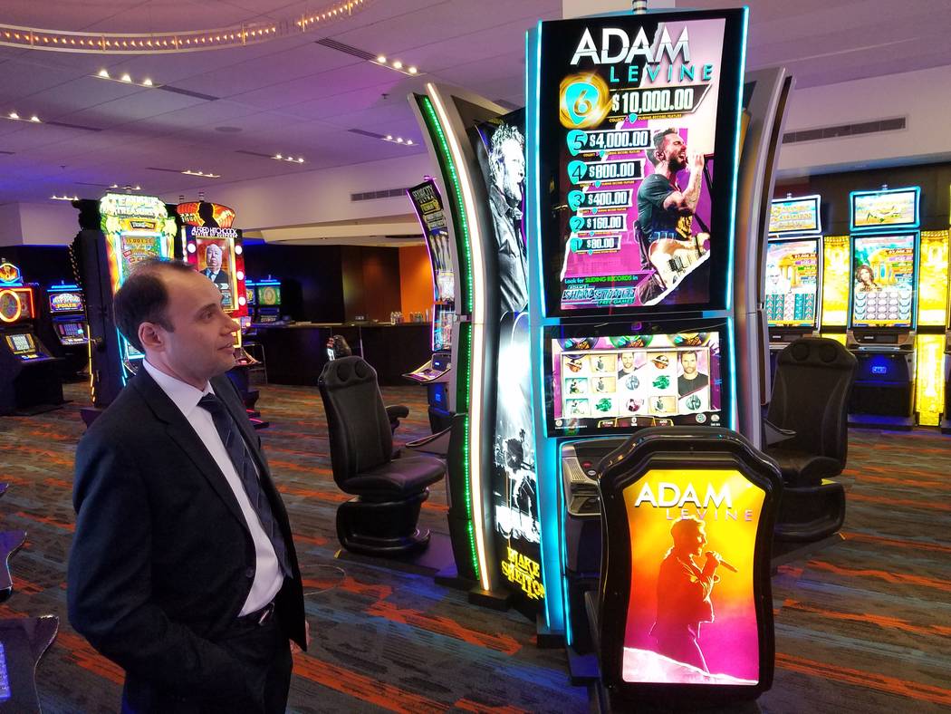 Nick Khin, IGT’s chief commercial officer for gaming, checks out the Adam Levine-themed slot machine at IGT's Las Vegas showroom on Friday, Sept. 28, 2018. The machine is one of IGT's offering t ...
