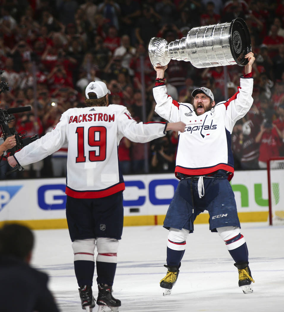 Washington Capitals left wing Alex Ovechkin (8) and center Nicklas Backstrom (19) celebrates after defeating the Golden Knights in Game 5 of the Stanley Cup Final to win the series at T-Mobile Are ...