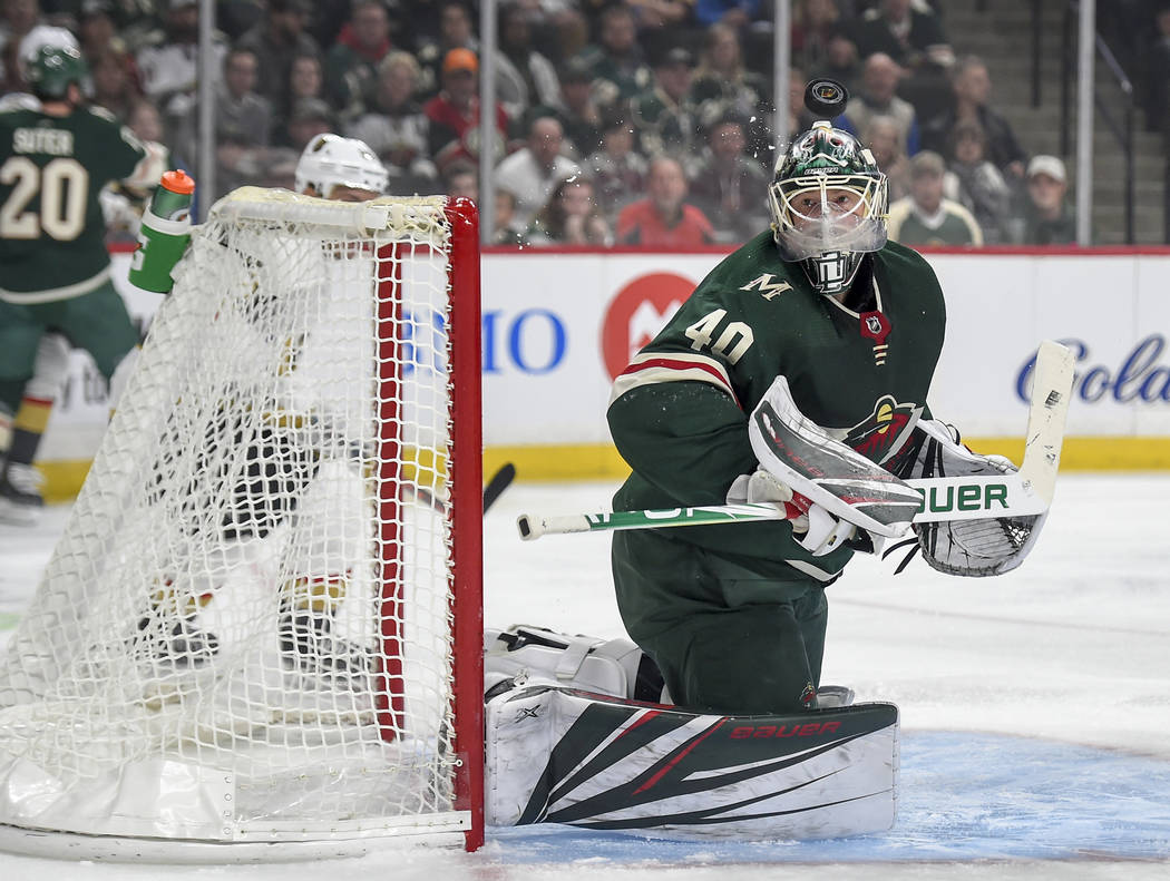 Minnesota Wild goalie Devan Dubnyk stops a shot on goal by the Vegas Golden Knights in the first period during an NHL hockey game Saturday, Oct. 6, 2018, in St. Paul, Minn. (AP Photo/Craig Lassig)