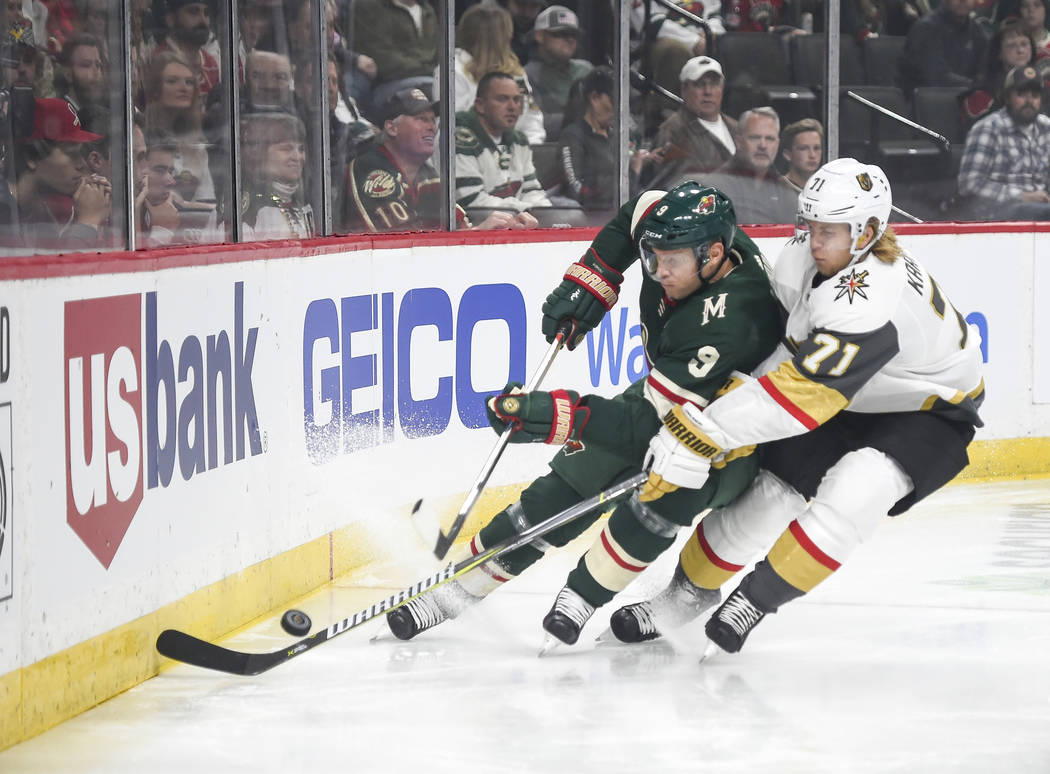 Minnesota Wild center Mikko Koivu (9) and Vegas Golden Knights center William Karlsson (71) battle for the puck in the first period during an NHL hockey game Saturday, Oct. 6, 2018, in St. Paul, M ...