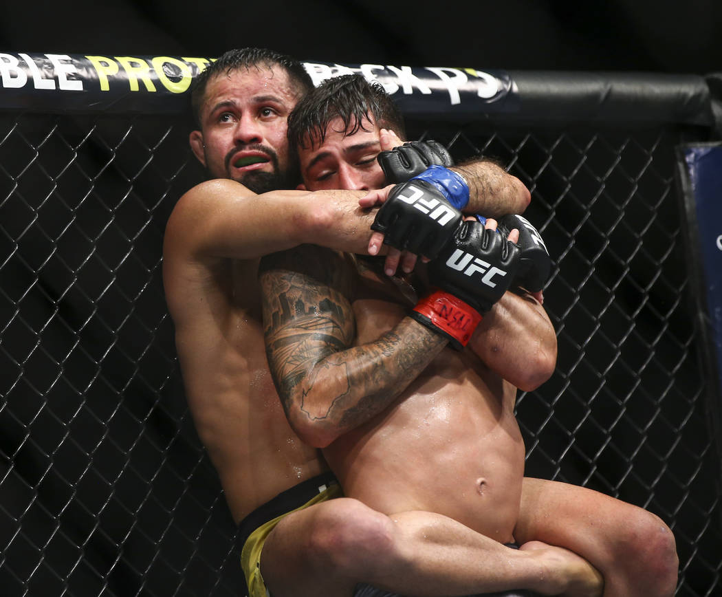 Jussier Formiga, left, grapples with Sergio Pettis against the octagon cage during their flyweight bout at UFC 229 at T-Mobile Arena in Las Vegas on Saturday, Oct. 6, 2018. Chase Stevens Las Vegas ...