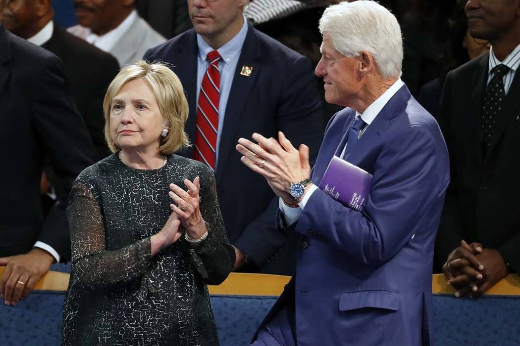 Former President Bill Clinton and wife Hillary Clinton applaud during the funeral for Aretha Franklin at Greater Grace Temple, Friday, Aug. 31, 2018, in Detroit. The Clintons will be coming to Las ...