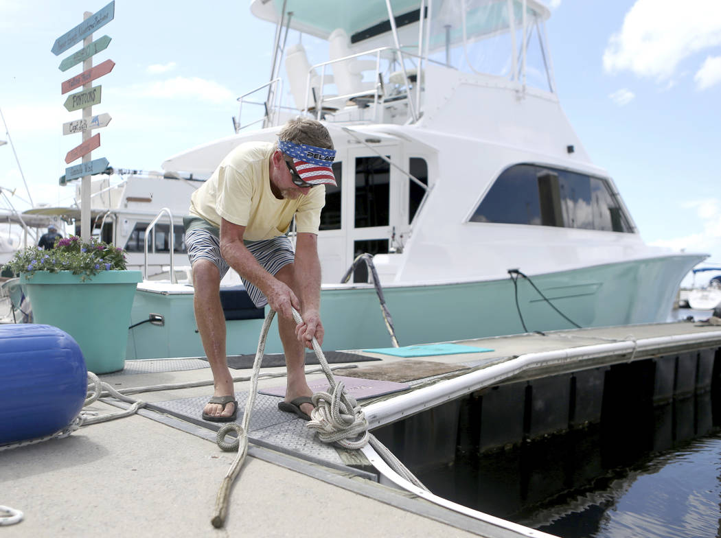 Rob Docko ties a knot while securing his boat at the St. Andrews Marina in Panama City, Fla., Monday, Oct. 8, 2018, to prepare for Hurricane Michael. (Patti Blake /News Herald via AP)
