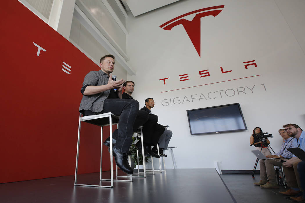 Elon Musk, CEO of Tesla Motors Inc., left, discusses the company's new Gigafactory Tuesday, July 26, 2016, in Sparks, Nev. (Rich Pedroncelli/AP)