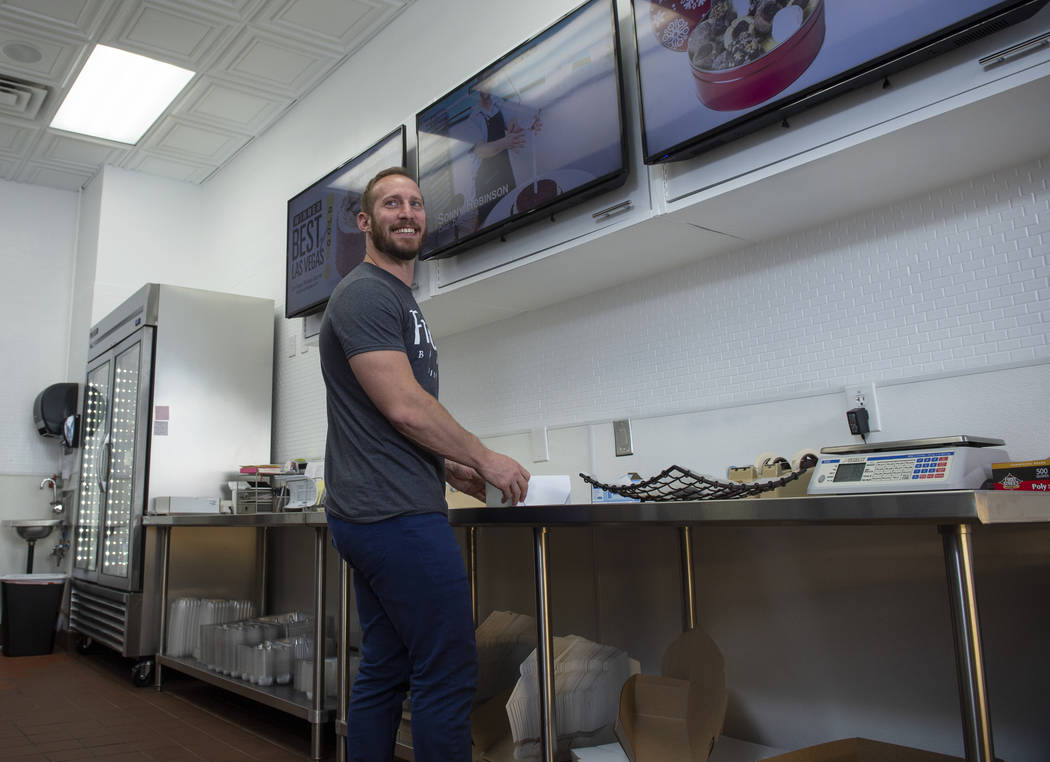 Max Jacobson-Fried, owner of Freed's Bakery, boxes up various sweet treats in Freed's newest location at 6475 N. Decatur Blvd. in the Shadow Mountain Marketplace, just north of the northern 215 Be ...
