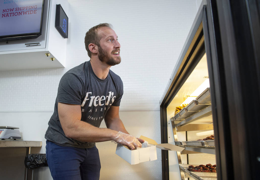 Max Jacobson-Fried, owner of Freed's Bakery, places a cookie in a container to box up in Freed's newest location at 6475 N. Decatur Blvd. in the Shadow Mountain Marketplace, just north of the nort ...
