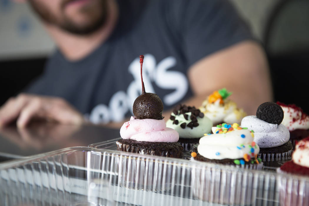 A container of cupcakes, boxed up by owner Max Jacobson-Fried, sits on top of the counter at Freed's Bakery at its newest location at 6475 N. Decatur Blvd. in the Shadow Mountain Marketplace, just ...