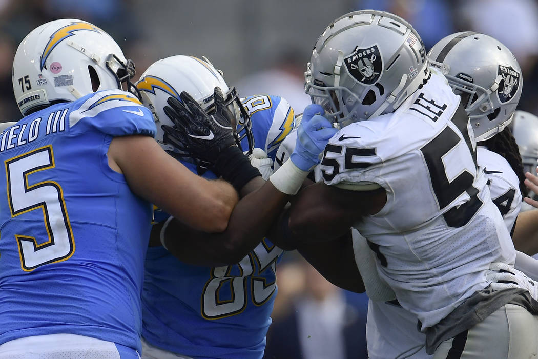 Los Angeles Chargers tight end Antonio Gates, left, and Oakland Raiders linebacker Marquel Lee (55) scuffle after a play during the second half of an NFL football game Sunday, Oct. 7, 2018, in Car ...