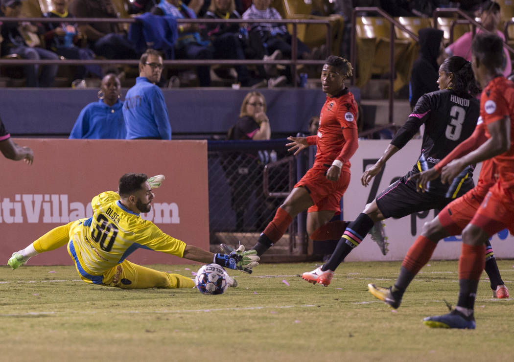 Las Vegas FC goalkeeper Thomas Olsen (30) makes a save with the help of defender Joel Huiqui (3) in the first half during their United Soccer League game with the Phoenix Rising on Wednesday, Oct. ...