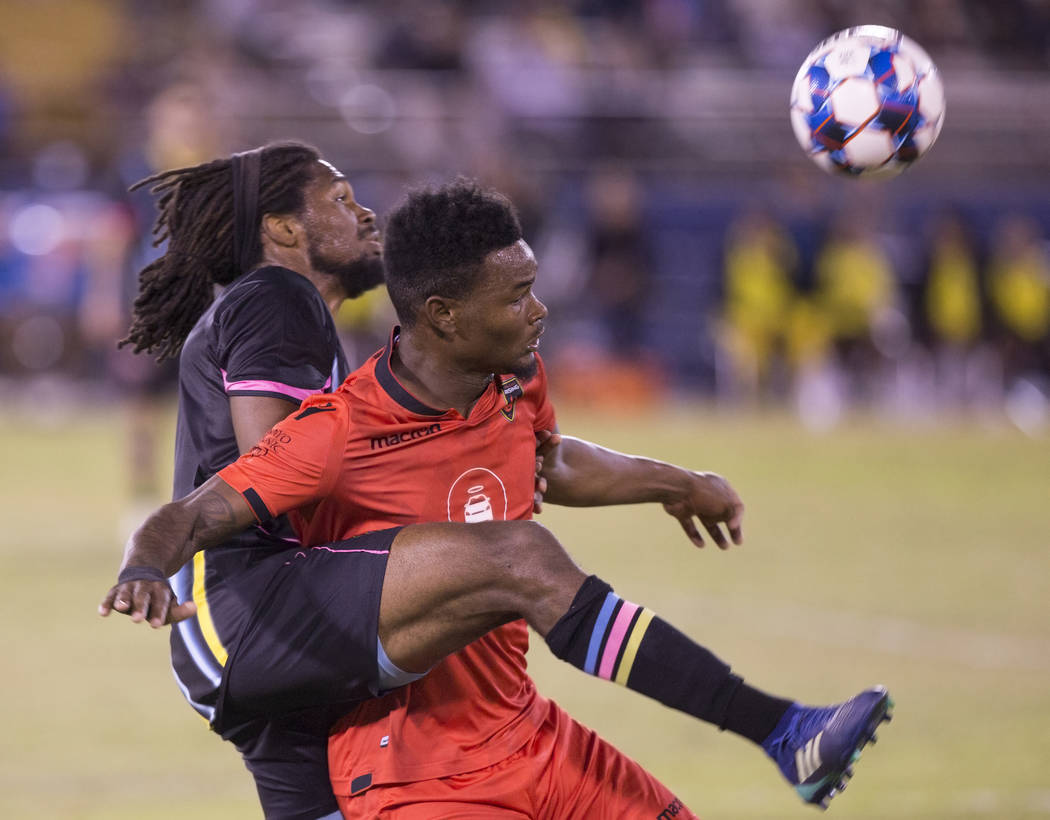 Las Vegas Lights defender Carter Manley (2) fights for possession with Phoenix Rising forward Kevaughn Frater (51) in the first half on Wednesday, Oct. 10, 2018, at Cashman Field, in Las Vegas. Be ...