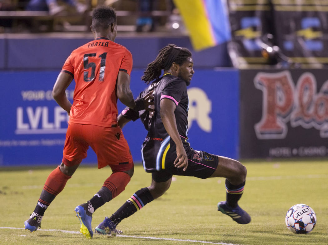Las Vegas Lights defender Carter Manley (2) pushes the ball up field past Phoenix Rising forward Kevaughn Frater (51) in the first half on Wednesday, Oct. 10, 2018, at Cashman Field, in Las Vegas. ...
