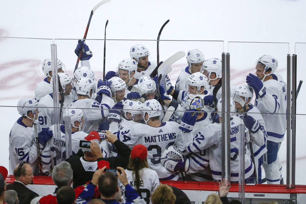 Toronto Maple Leafs defenseman Morgan Rielly (44) celebrates with teammates after scoring in overtime of an NHL hockey game against the Chicago Blackhawks Sunday, Oct. 7, 2018, in Chicago. (AP Pho ...