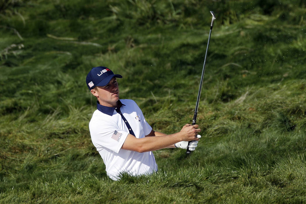 Jordan Spieth of the US plays out of a bunker on the 4th hole during his foursome match on the second day of the 2018 Ryder Cup at Le Golf National in Saint Quentin-en-Yvelines, outside Paris, Fra ...