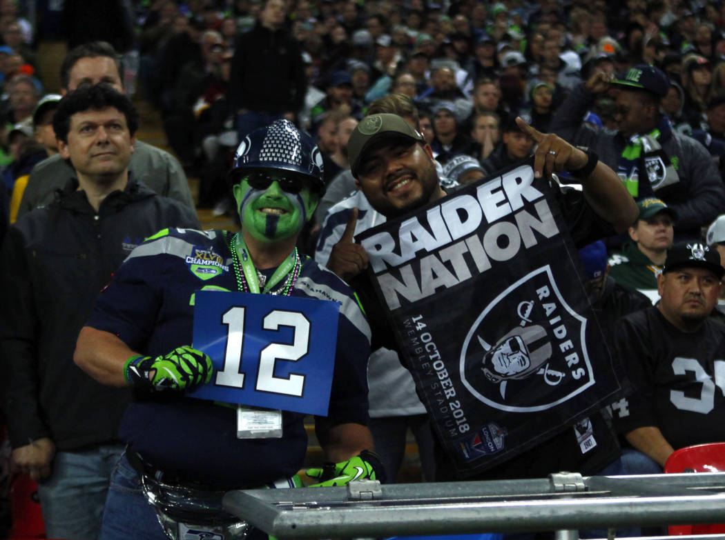 A Seattle Seahawks fan and Oakland Raiders fan pose together during the first half of an NFL game at Wembley Stadium in London, England, Sunday, Oct. 14, 2018. Heidi Fang Las Vegas Review-Journal ...
