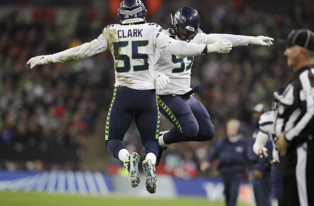 Seattle Seahawks defensive end Frank Clark (55) celebrates with defensive end Branden Jackson (93) after he sacked Oakland Raiders quarterback Derek Carr (4) during the first half of an NFL footba ...