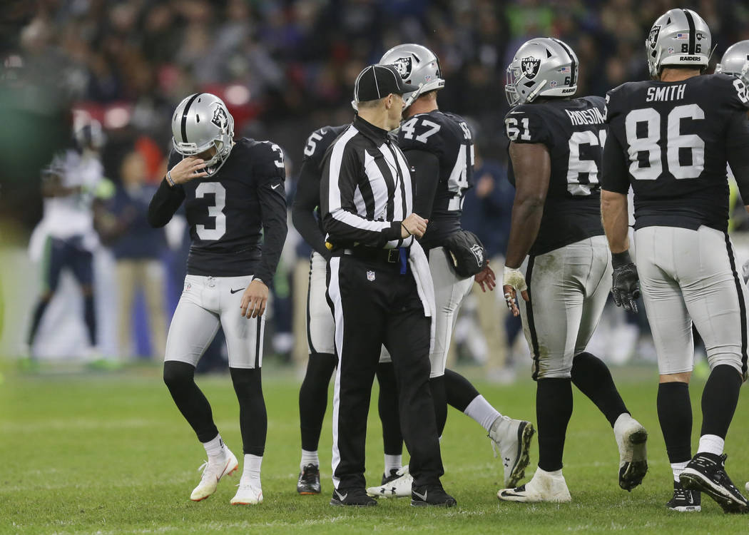 Oakland Raiders kicker Matt McCrane (3), left, reacts after missing a field goal during the first half of an NFL football game against Seattle Seahawks at Wembley stadium in London, Sunday, Oct. 1 ...