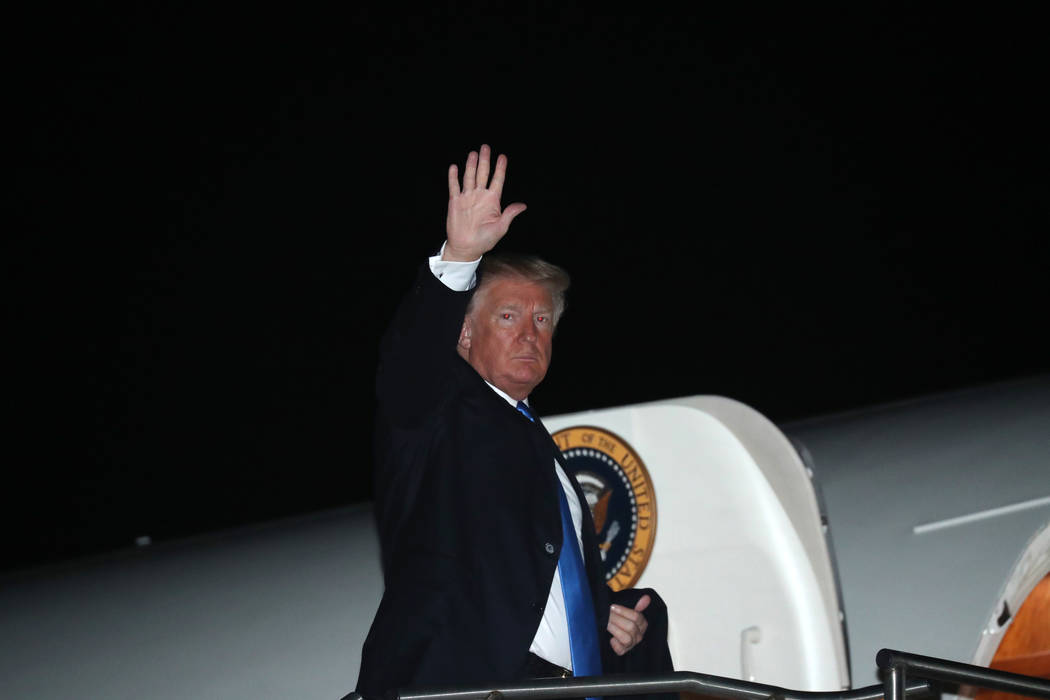 President Donald Trump boards Air Force One at Blue Grass Airport in Lexington, Ky., Saturday, Oct. 13, 2018, after speaking at a rally in Richmond, Ky. (AP Photo/Andrew Harnik)