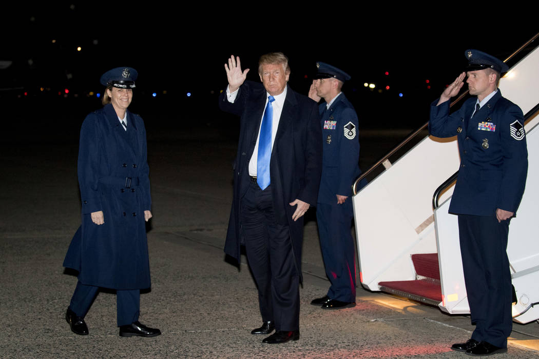 President Donald Trump waves to members of the media as he arrives at Andrews Air Force Base, Md., Saturday, Oct. 13, 2018, to board Marine One for a short trip to the White House after traveling ...