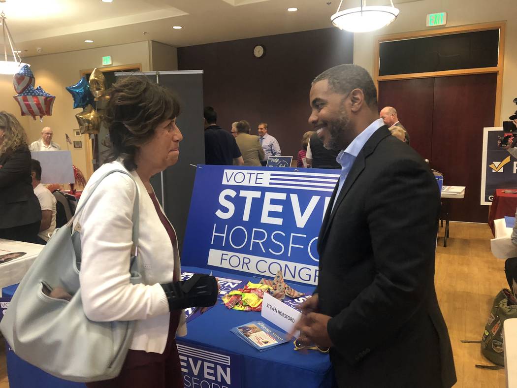 Democrat Steven Horsford, who is running in Nevada's 4th Congressional District, chats with a voter at a candidate meet-and-greet Monday hosted by the North Las Vegas Alliance of Homeowner Associa ...