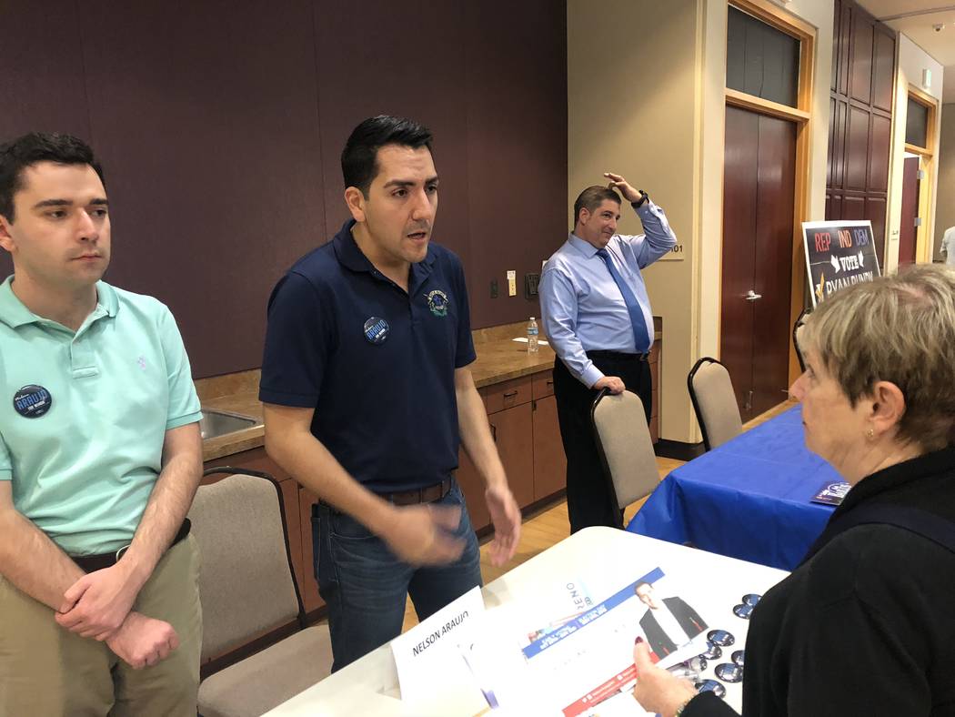Nevada Assemblyman Nelson Araujo, who is running for secretary of state, chats with a voter at a candidate meet-and-greet Monday hosted by the North Las Vegas Alliance of Homeowner Associations an ...