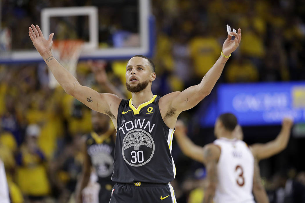 Golden State Warriors guard Stephen Curry (30) celebrates during the second half of Game 2 of basketball's NBA Finals between the Warriors and the Cleveland Cavaliers in Oakland, Calif., Sunday, J ...
