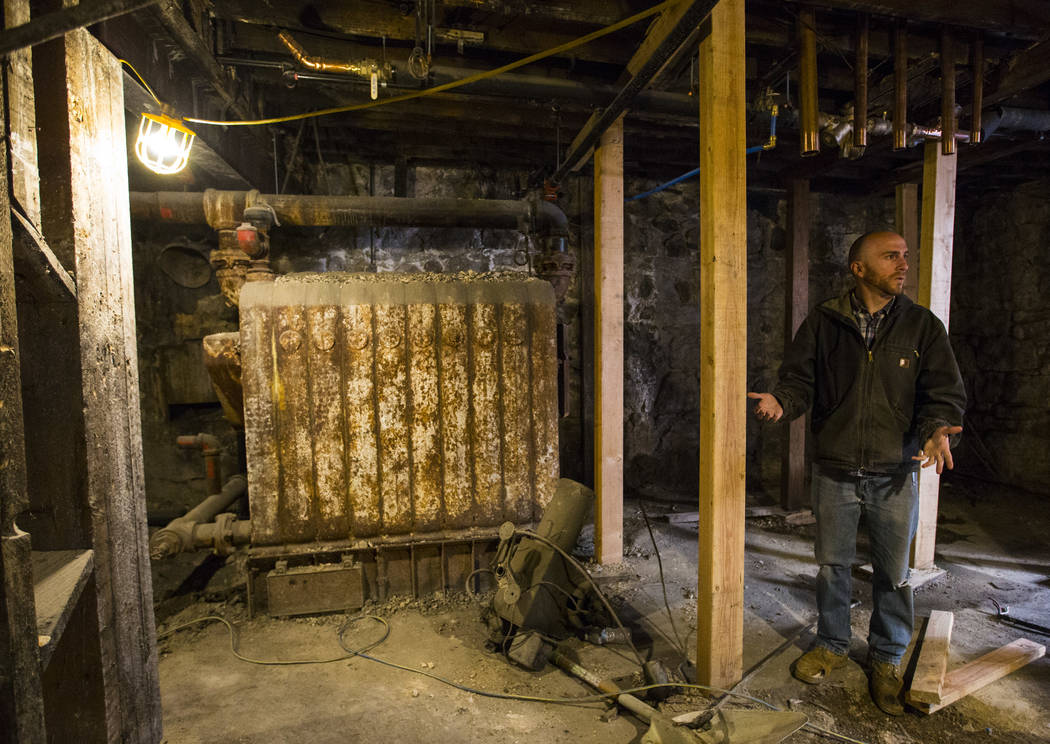 Ramsey Cline talks about the old boiler in the basement level as renovations go on at the Belvada in Tonopah on Friday, Oct. 12, 2018. The Belvada originally opened as the State Bank and Trust Com ...