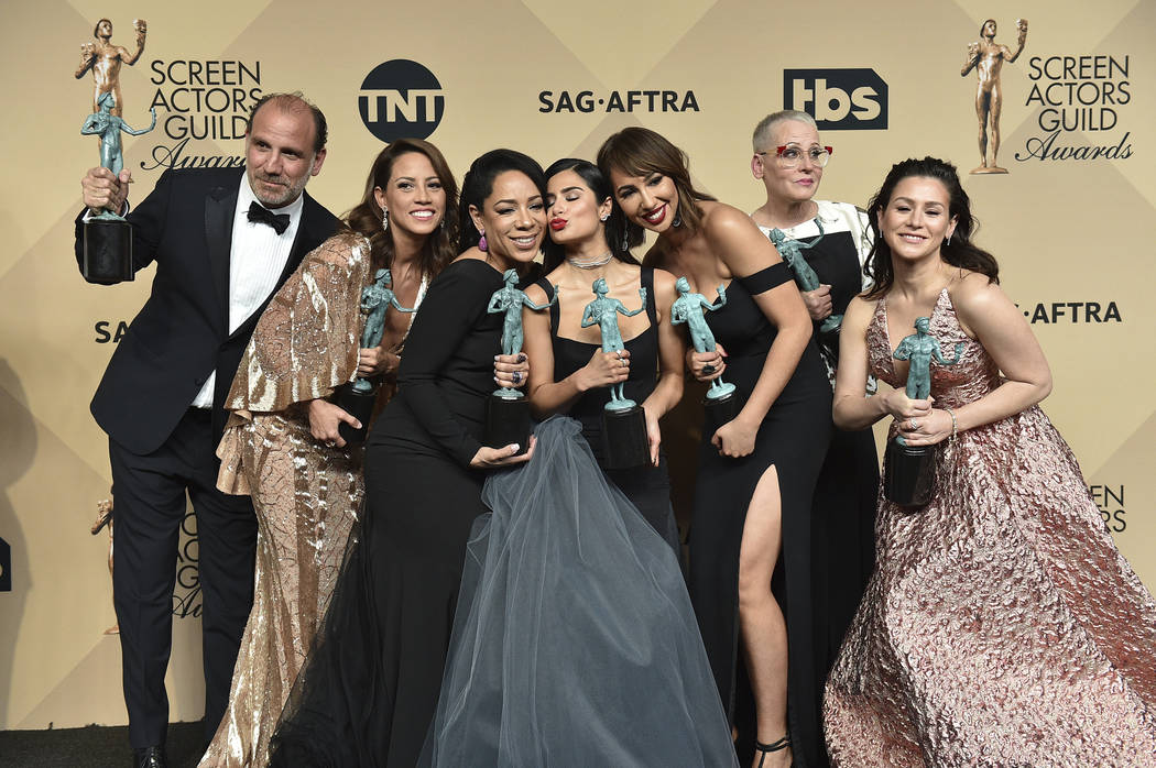In this Sunday, Jan. 29, 2017 file photo, Nick Sandow, from left, Elizabeth Rodriguez, Selenis Leyva, Diane Guerrero, Jackie Cruz, Lori Petty and Yael Stone pose in the press room with the award f ...