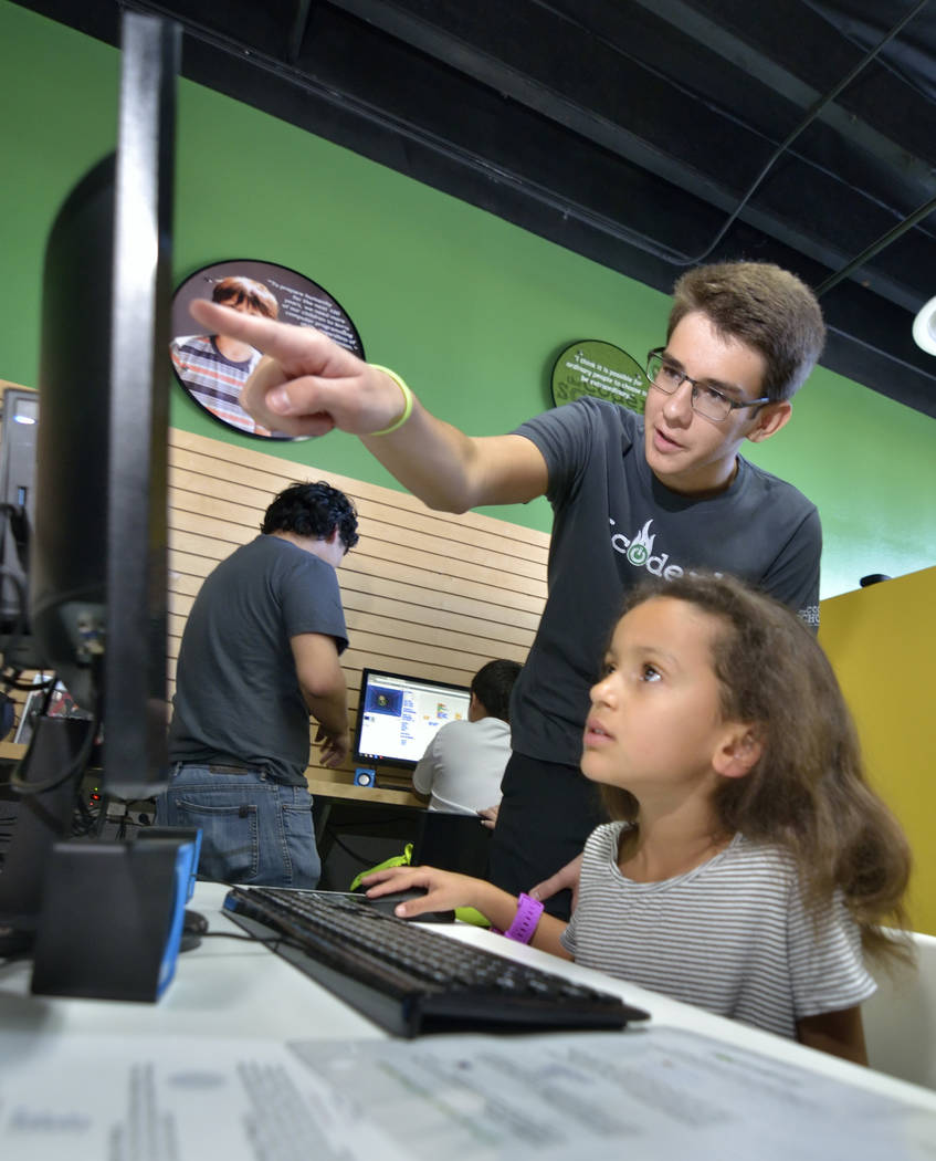 Code coach Alexander Schupp, standing, works with Camila Rogier, 5, of Las Vegas during the grand opening of theCoderSchool at 9330 W. Sahara Ave. in Las Vegas on Saturday, Oct. 20, 2018. Bill Hug ...